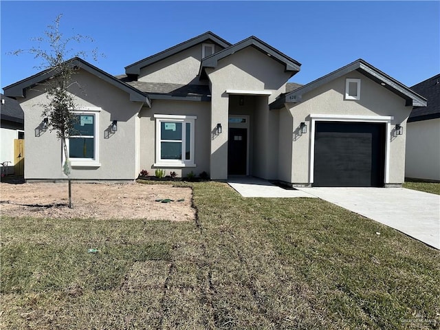 view of front of home featuring a garage and a front yard