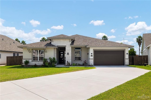 view of front of property with a garage and a front lawn