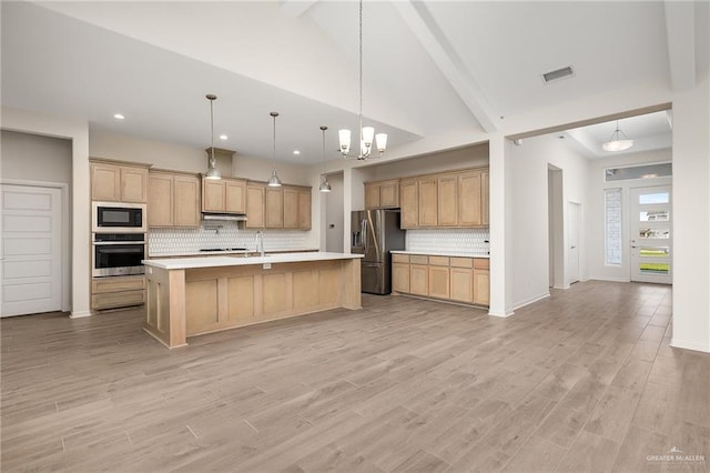 kitchen with tasteful backsplash, light hardwood / wood-style flooring, and stainless steel appliances