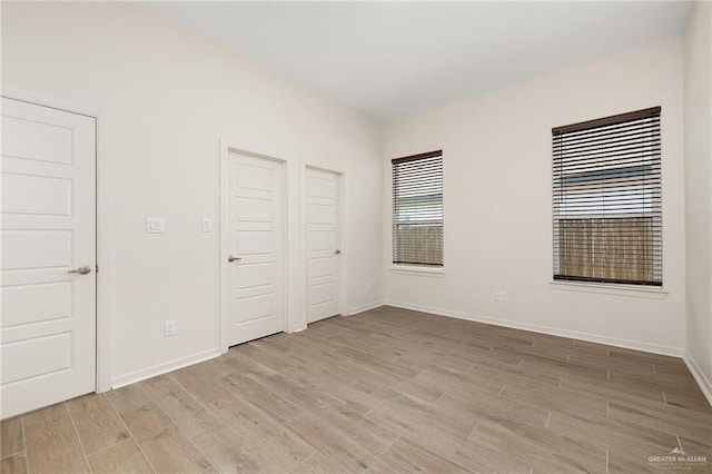 unfurnished bedroom with light wood-type flooring