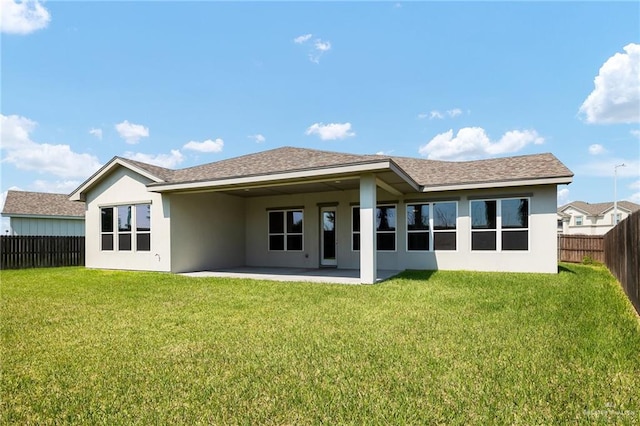 rear view of house with a yard and a patio