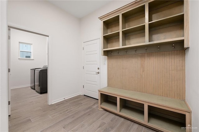 mudroom featuring washing machine and dryer and light hardwood / wood-style floors