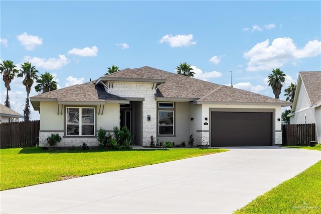 view of front of property with a front lawn and a garage