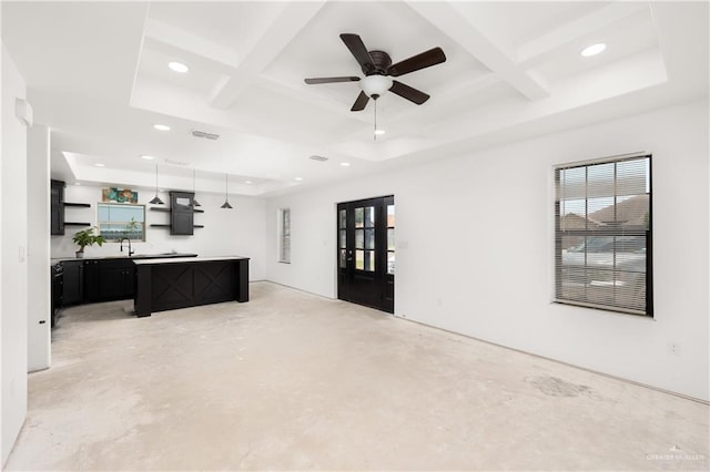 living room with beam ceiling, ceiling fan, coffered ceiling, and sink