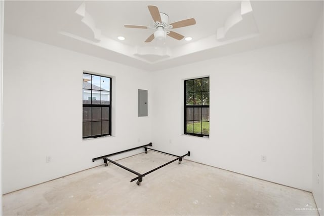 interior space with a tray ceiling and multiple windows