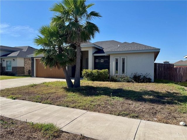 8706 Pink Flamingo St, Harlingen, TX 78552 - view of front facade featuring stucco siding, driveway, and a garage