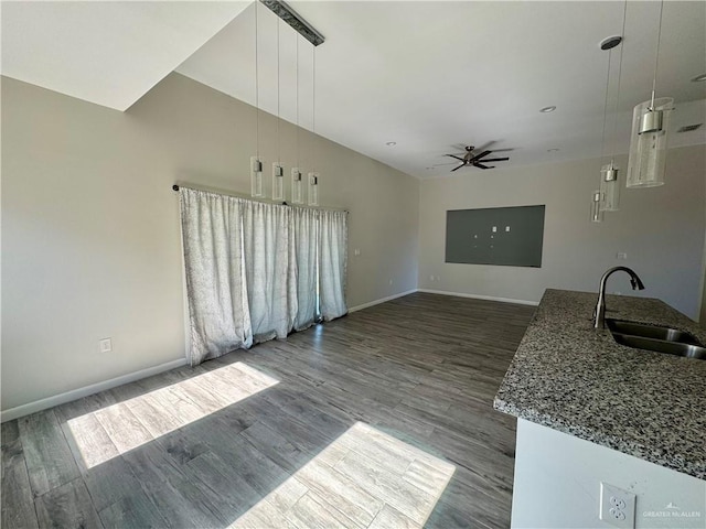 8706 Pink Flamingo St, Harlingen, TX 78552 - unfurnished living room featuring a sink, wood finished floors, ceiling fan, baseboards, and vaulted ceiling