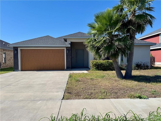 8706 Pink Flamingo St, Harlingen, TX 78552 - view of front of home with a garage, driveway, stucco siding, and a shingled roof