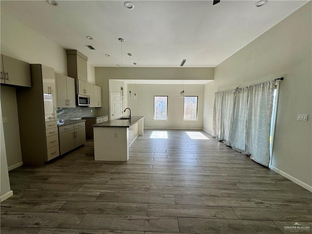 8706 Pink Flamingo St, Harlingen, TX 78552 - kitchen featuring stainless steel microwave, a sink, dark wood-style flooring, baseboards, and recessed lighting