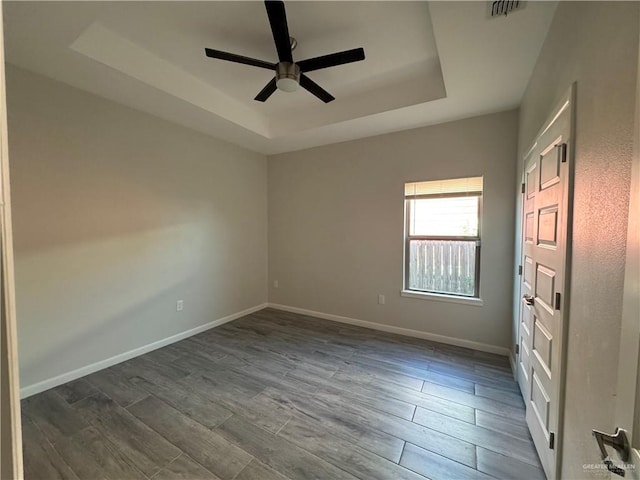 8706 Pink Flamingo St, Harlingen, TX 78552 - spare room with a raised ceiling, ceiling fan, wood finish floors, and baseboards