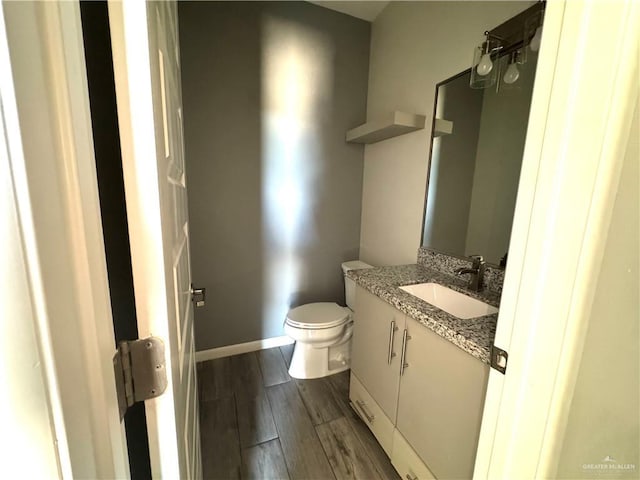 8706 Pink Flamingo St, Harlingen, TX 78552 - half bathroom with toilet, wood finished floors, vanity, and baseboards