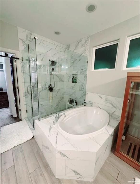 full bath featuring a marble finish shower and a bath