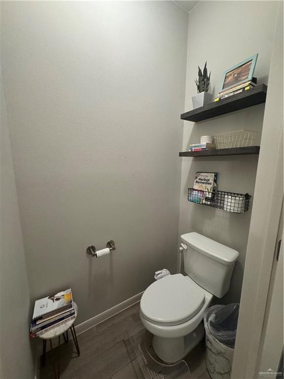 bathroom with wood-type flooring and toilet