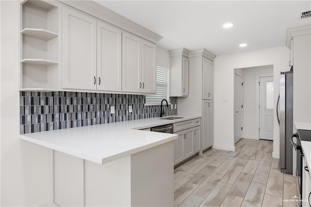 321 E Stubbs St, Edinburg, TX 78539 - kitchen with stainless steel appliances, tasteful backsplash, a peninsula, light countertops, and recessed lighting