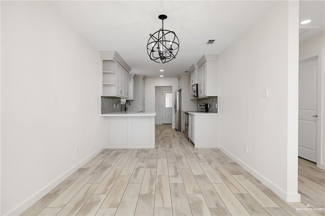 321 E Stubbs St, Edinburg, TX 78539 - kitchen featuring stainless steel appliances, open shelves, light countertops, light wood-style floors, and recessed lighting
