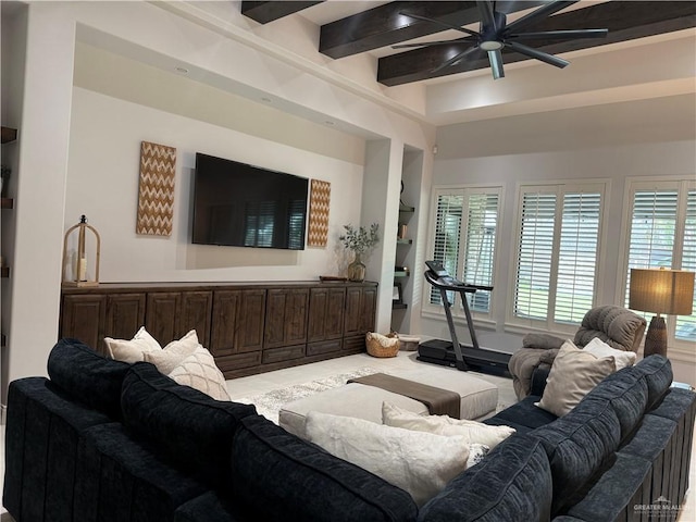 living room featuring beamed ceiling, ceiling fan, and built in shelves