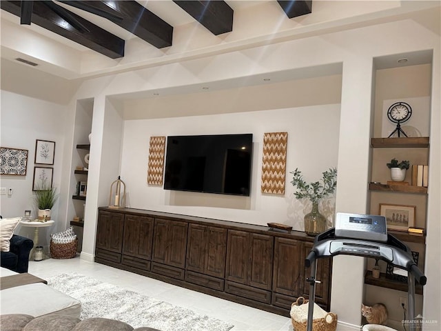 living room featuring beamed ceiling and built in features