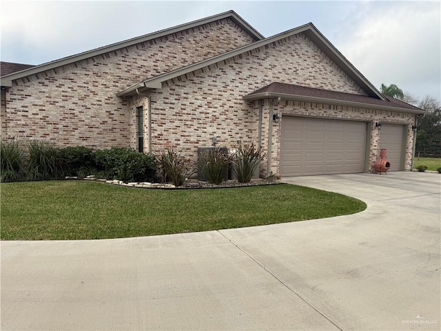 view of side of home featuring a garage and a lawn