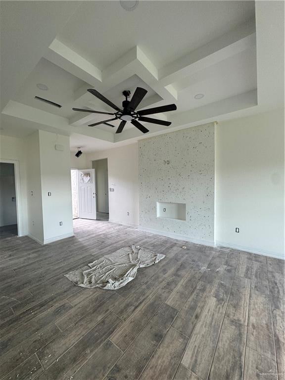 interior space featuring ceiling fan, beamed ceiling, and dark wood-type flooring