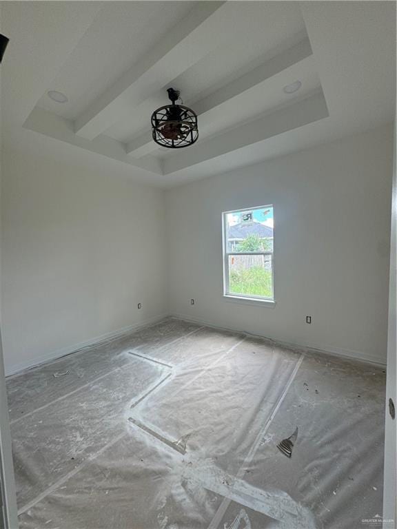 spare room featuring beamed ceiling