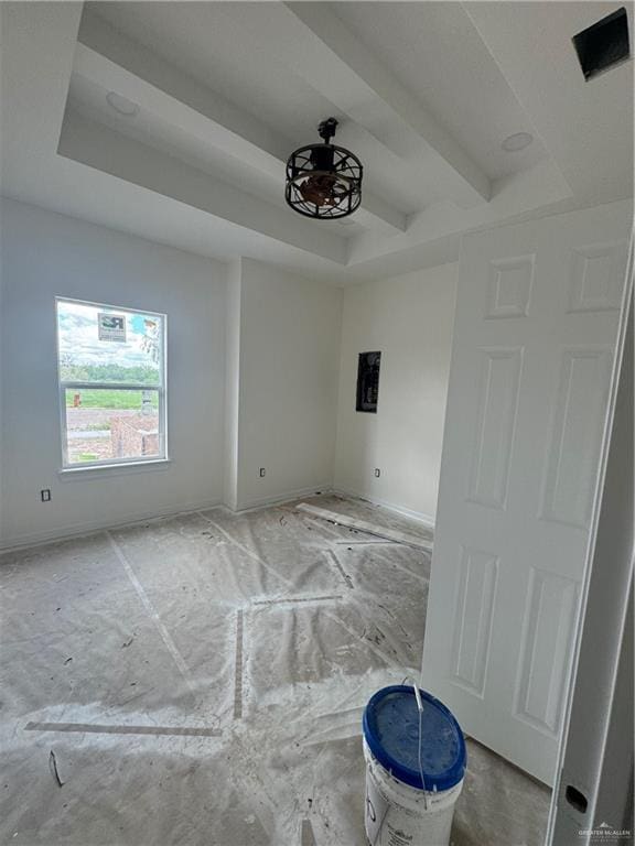 unfurnished room featuring beam ceiling