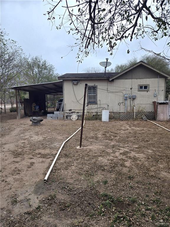 rear view of house featuring a carport