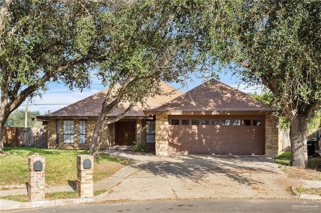 view of front of property featuring a garage and a front lawn