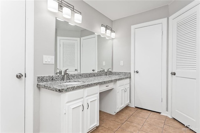 bathroom with tile patterned flooring and vanity