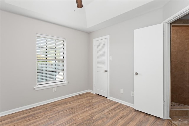 unfurnished bedroom with a closet, ceiling fan, and hardwood / wood-style floors