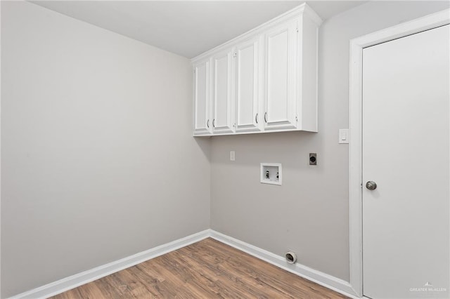 laundry room with electric dryer hookup, cabinets, hookup for a washing machine, and wood-type flooring