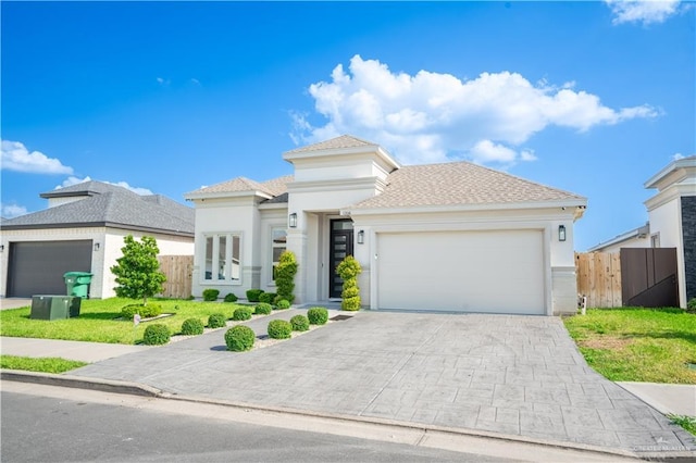 1306 E Danielle Ave, Pharr, TX 78577 - view of front facade with a garage, stucco siding, decorative driveway, and a shingled roof