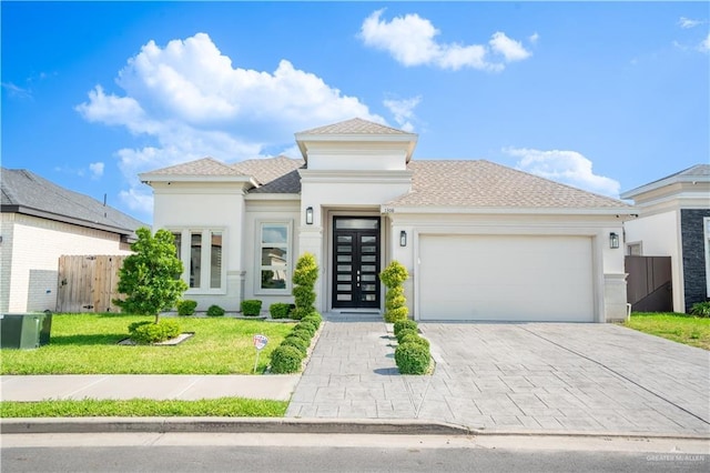 1306 E Danielle Ave, Pharr, TX 78577 - prairie-style home featuring an attached garage, driveway, stucco siding, and a shingled roof