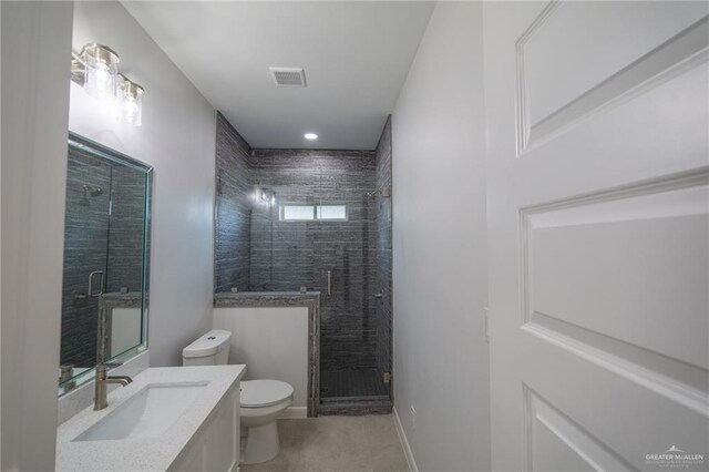 1306 E Danielle Ave, Pharr, TX 78577 - bathroom with toilet, vanity, a stall shower, and tile patterned floors