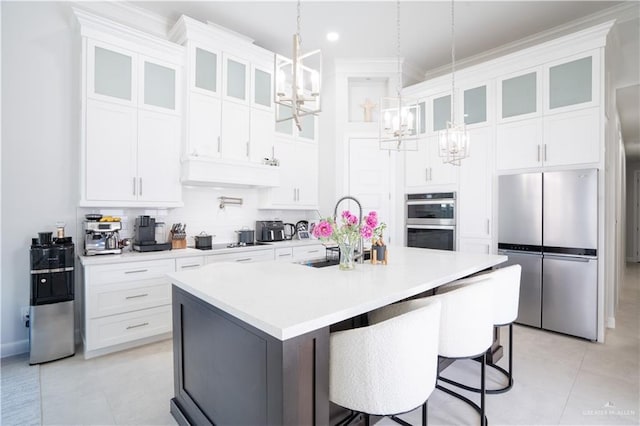 1306 E Danielle Ave, Pharr, TX 78577 - kitchen featuring stainless steel appliances, a chandelier, a sink, white cabinetry, and light countertops