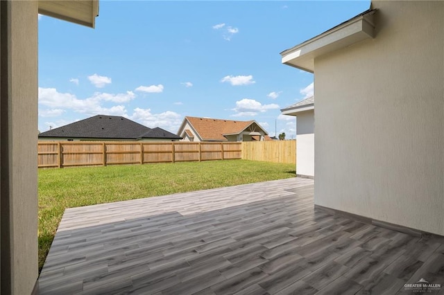 wooden deck with a lawn