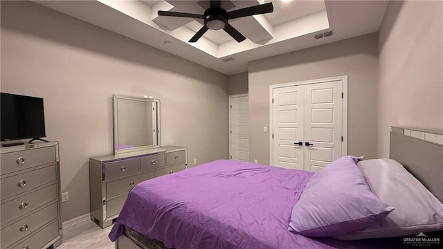 bedroom with a tray ceiling and ceiling fan