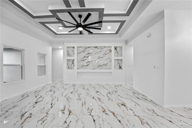 unfurnished living room with coffered ceiling, marble finish floor, built in shelves, and baseboards