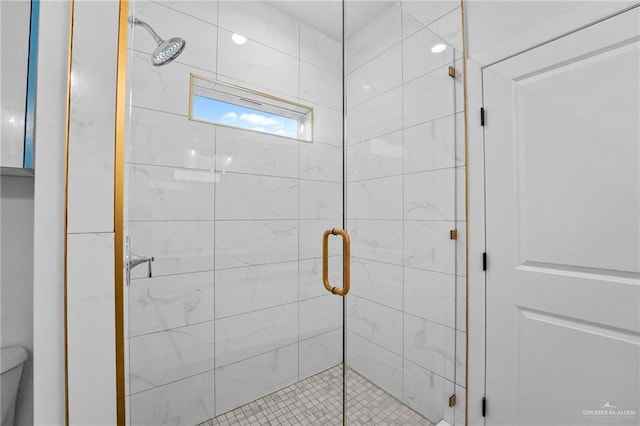 full bathroom with a stall shower and toilet