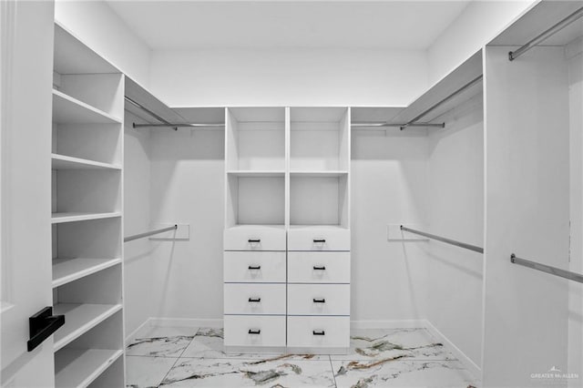 walk in closet with marble finish floor