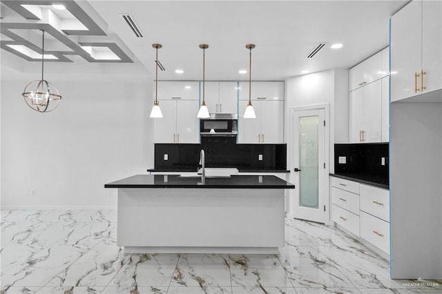kitchen with tasteful backsplash, visible vents, stainless steel microwave, dark countertops, and white cabinets