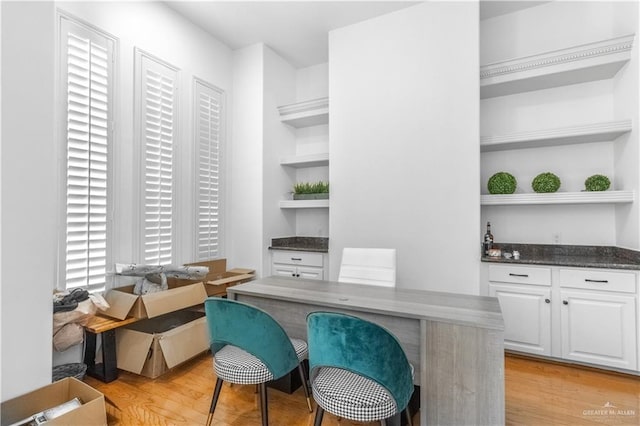 bar featuring white cabinetry and light wood-type flooring