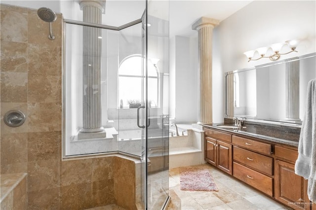 bathroom with vanity, decorative columns, and an enclosed shower