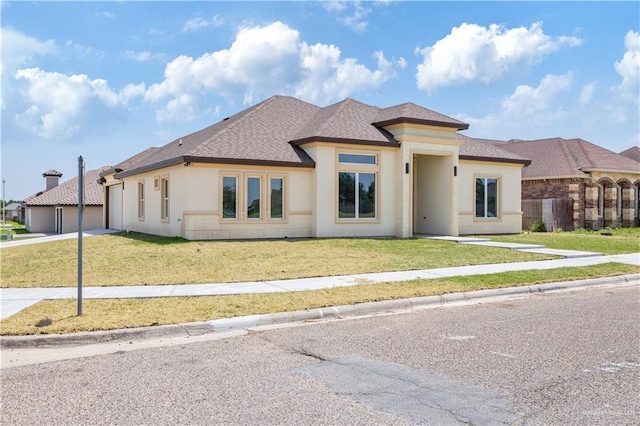 2400 Windmill Palm, Rio Grande City, TX 78582 - prairie-style home with driveway, a shingled roof, a front yard, and stucco siding