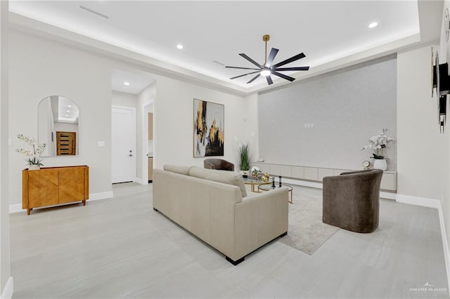 2700 W Chesterfield Ave, Edinburg, TX 78539 - living room featuring a raised ceiling, baseboards, a ceiling fan, and recessed lighting
