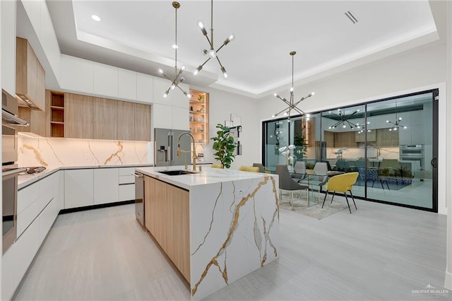 2700 W Chesterfield Ave, Edinburg, TX 78539 - kitchen featuring an inviting chandelier, a sink, modern cabinets, and a tray ceiling