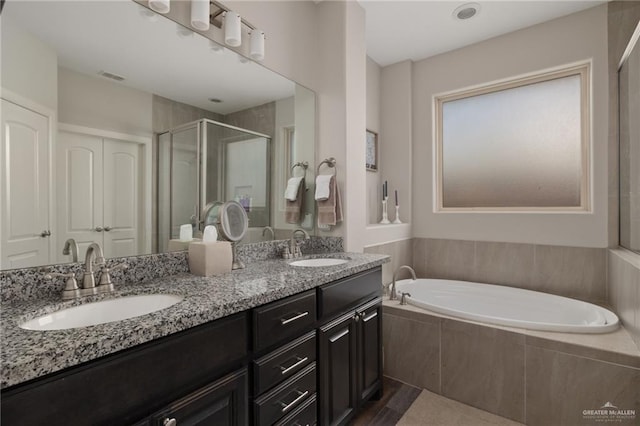 5116 Escondido Pass, Mcallen, TX 78504 - bathroom featuring a stall shower, a garden tub, double vanity, and a sink