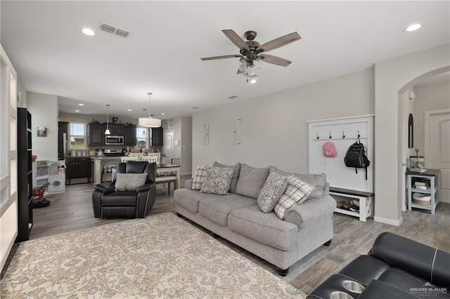 5116 Escondido Pass, Mcallen, TX 78504 - living room with arched walkways, ceiling fan, light wood-type flooring, and visible vents