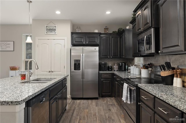 5116 Escondido Pass, Mcallen, TX 78504 - kitchen featuring tasteful backsplash, appliances with stainless steel finishes, a sink, and wood finished floors