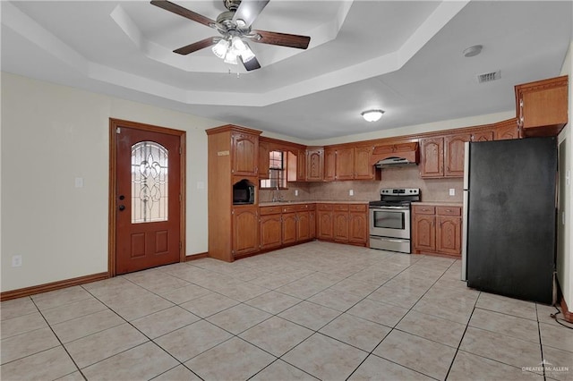 kitchen with ventilation hood, refrigerator, a raised ceiling, electric range, and light tile patterned floors