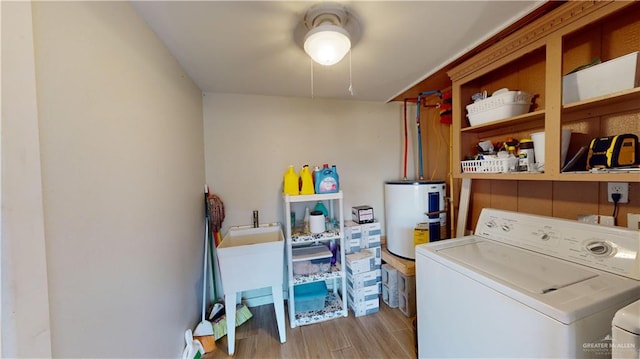 washroom with electric water heater and independent washer and dryer